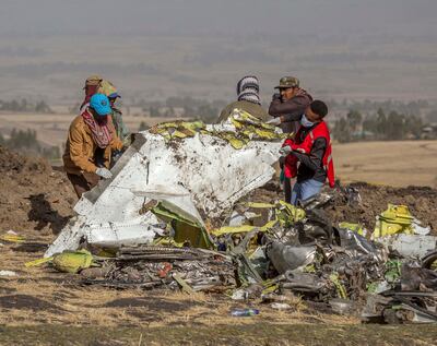Workers recover debris at the scene of an Ethiopian Airlines Boeing Max plane crash in March 2019 outside of Addis Ababa. AP