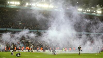 Leicester players dejected as smoke passes from flares after Aston Villa's second goal scored by Trezeguet. Reuters