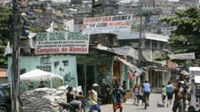 Residents of the Complexo de Alemao slum walk past a security check-point in Rio de Janeiro.