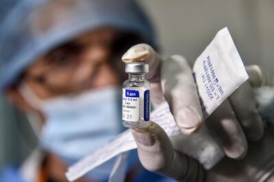 A medical worker holds a vial of Russia's Sputnik V vaccine for Covid-19 in Algeria. AFP