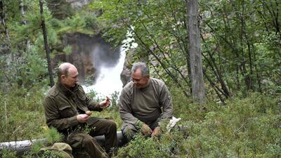 Mr Putin shows mushrooms to Defence Minister Sergei Shoigu during his vacation in the remote Tuva region in southern Siberia. Alexei Nikolsky / Sputnik, Kremlin Pool Photo via AP.