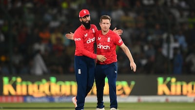 Liam Dawson celebrates the wicket of Babar Azam with Moeen Ali. Getty