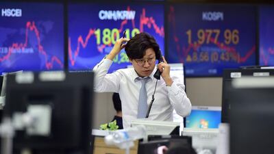 A Currency dealer talks over the telephone as he monitors exchange rates in a trading room at the KEB Hana Bank in Seoul on December 17, 2015. AFP