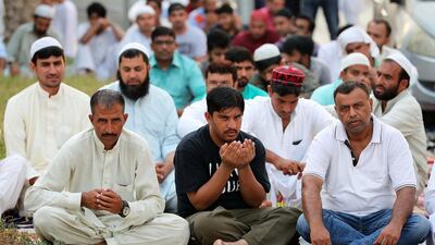 People pray near Jumeirah Mosque in Dubai during the Eid Al Adha prayers. Pawan Singh/The National