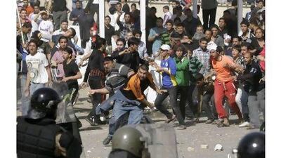 Iraqi riot police officers prevent anti-government protesters from entering the heavily guarded Green Zone during a demonstration in Baghdad on Friday.