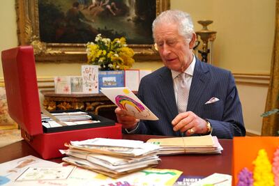 Britain's King Charles reads cards and messages, sent by well-wishers following his cancer diagnosis, in London last month. Reuters