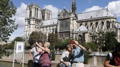 3rd: Paris. Tourists take selfies outside Notre Dame Cathedral in Paris. The Notre Dame Cathedral greets some 13 million tourists a year according to its official website. The cathedral, with its construction dating from 1163, is an important example of French Gothic architecture, sculpture and stained glass. Charles Platiau / Reuters