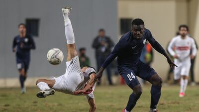 Zamalek player Ahmed Fatouh (L) attempts a bicycle kick next to Enppi player John Ebuka during the Egyptian Premier League soccer match between ENPPI and Zamalek SC at Petrosport Stadium in Cairo, Egypt. EPA