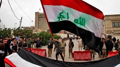 Security forces close the area while university students hold national flags during a protest in front of the Ministry of Higher Education and Scientific Research in Baghdad, Iraq. AP Photo