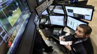 Michael Sollitto watches the Federal Reserve's interest rate decision as he works on the floor of the New York Stock Exchange.