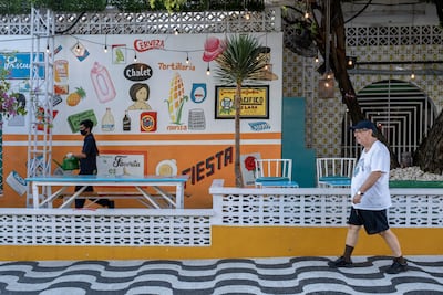 A man walks past an empty restaurant at a tourist area in Kuta, Bali, Indonesia. EPA