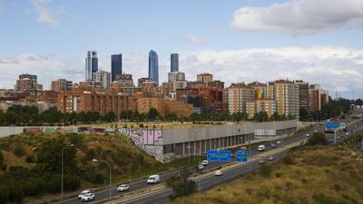 The four towers of the Cuatro Torres Business Area stand beyond residential housing blocks in Madrid. Angel Navarrete/Bloomberg