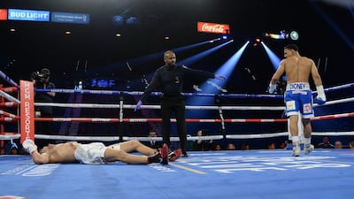 Rolando Romero (blue trunks) knocks down Arturs Ahmetovs (white trunks) during their lightweight bout at MGM Grand Garden Arena, Las Vegas. Reuters