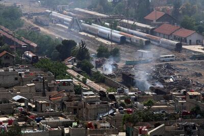 Firefighters extinguish a blaze at a train station near Yarmouk on the southern edge of Damascus during regime shelling targeting ISIS on April 28, 2018. Maher Al Mounes / AFP