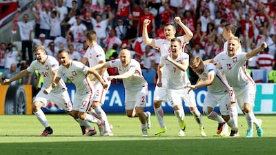 Poland players celebrate their team’s shootout win against Switzerland. Valery Hache / AFP