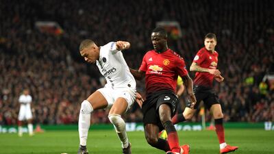 Paris Saint-Germain's Kylian Mbappe is tackled by Manchester United's Eric Bailly. Getty Images