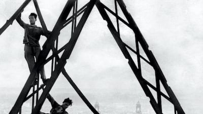 Picture released in the 30s in Paris shows "acrobatic" workers on the Eiffel Tower in front of the Trocadero Palace. AFP