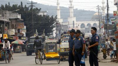 Filipino policemen by the spot where the head of John Ridsdel was dropped off, in Jolo, Sulu Island, southern Philippines. Ben Hajan / EPA