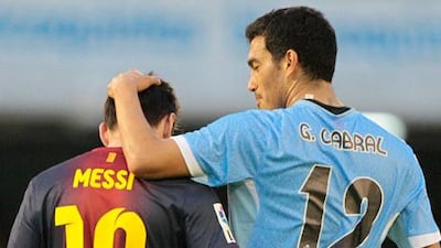 Barcelona´s Lionel Messi is congratulated by Celta's Gustavo Cabral after his record-breaking goal.
