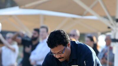 A pair of turtles are placed on the sand to make their way to the sea as part of the release scheme. Pawan Singh / The National