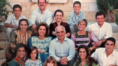 King Hussein, centre, and Queen Noor sit among their 12 children in this picture provided by the Royal Palace in 1995. AP Photo