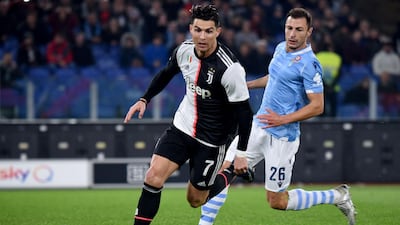 Cristiano Ronaldo outruns Lazio's Romanian defender Stefan Radu. AFP