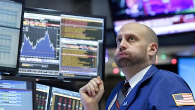 Specialist Meric Greenbaum works at his post on the floor of the New York Stock Exchange. Richard Drew / AP Photo