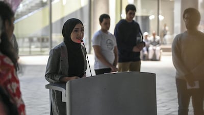 Lama Ahmad, a student at NYUAD and organiser of the vigil, gives a speech. Khushnum Bhandari for The National