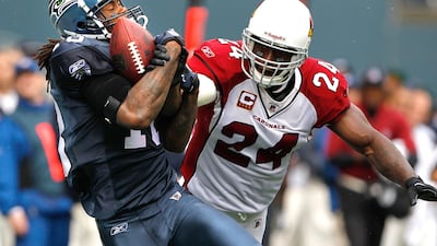 Seattle Seahawks' Sidney Rice, left, catches a pass under pressure from Arizona Cardinals' Adrian Wilson in the first half of a NFL football game, Sunday, Sept. 25, 2011, in Seattle. Elaine Thompson / AP Photo