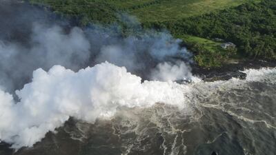 Hot lava entering the Pacific Ocean creates a dense white plume called 'laze', short for lava haze, in southeast of Pahoa, during ongoing eruptions of the Kilauea Volcano in Hawaii on May 20. United States Geological Survey / Reuters