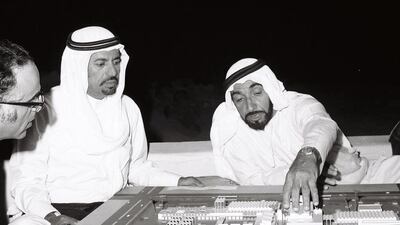 Sheikh Zayed looking at a model of an Islamic City with a number of officials in the early 1970s. (National Center for Documentation & Research)