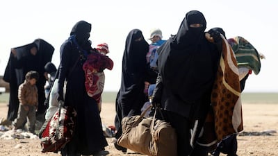 Civilians fleeing fighting between Syrian Democratic Forces (SDF) and ISIS militants in the frontline Syrian village of Baghuz, await to be screened and registered by the SDF in the countryside of the eastern Syrian Deir Ezzor province. AFP