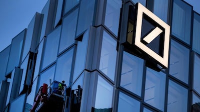 Workers clean one of the Deutsche Bank towers at its headquarters in Frankfurt. Bloomberg