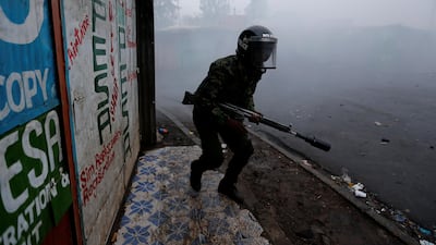 A riot policeman attempts to disperse supporters of Kenyan opposition leader Raila Odinga protesting the presidential election re-run in Kibera slums of Nairobi on October 26, 2017. Thomas Mukoya / Reuters