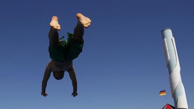 A boy jumping into the water to cool off from the heat at Grugabad open-air swimming pool on a hot summer day in Essen, Germany. Ina Fassbender/Reuters