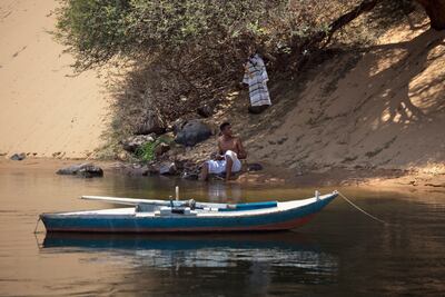 Aswan, Egypt - July 5, 2010: A man rests on the bank of the Nile River. ( Philip Cheung / for The National Magazine )
