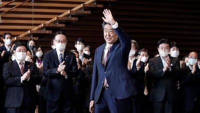 Japan's outgoing Prime Minister Shinzo Abe waves before leaving the prime minister's office. AP Photo