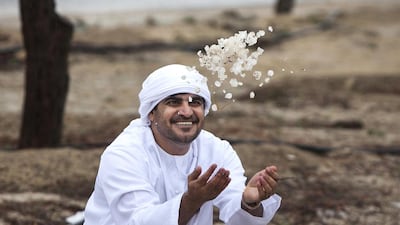 The novelty of hailstones attracts attention yesterday by the side of the E16 towards Sweihan. Silvia Razgova / The National