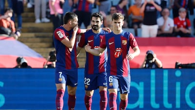 Barcelona's Ilkay Gundogan, centre, celebrates with Barcelona's Ferran Torres, left, and Barcelona's Gavi after scoring his side's opening goal. AP