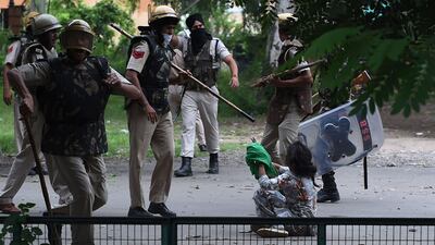 A follower of Indian religious leader Gurmeet Ram Rahim Singh pleads for her safety. Money Sharma / AFP Photo