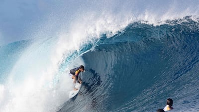A surfer competes during the 2019 Tahitian Teahupo'o surf trials at the famous break Teahupo'o. AFP