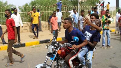A wounded man is taken away by motorbike. AFP