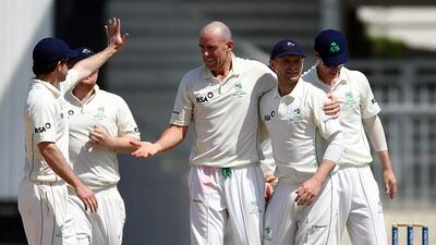The Australian-born Trent Johnston, centre, has claimed to be such a spent force that he has had to take help from his children to put on his socks. At 39, the fast bowler is eager to get into coaching. Satish Kumar / The National