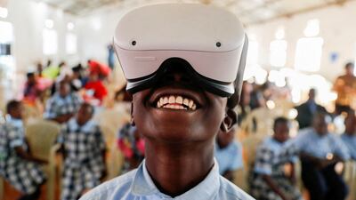 Francis Mwangi, 13, uses an Oculus virtual reality (VR) headset, to virtually visit Buckingham Palace, in Nyeri, Kenya. Reuters