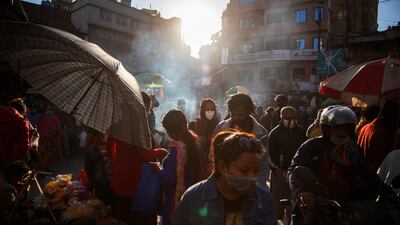 Shoppers crowd the Ason market during first day of the Tihar festival in Kathmandu, Nepal, on Friday, Nov. 13, 2020. During the five-day festival, also known as Yama panchak and similar to the Indian festival of Diwali, Hindus decorate their houses and worship Lakshmi, the goddess of wealth, and various animals like the crow, dog, cow and ox during the festival of lights. (AP Photo/Niranjan Shrestha)