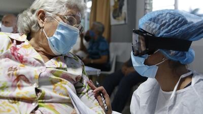 An elderly woman receives the Sinovac vaccine against Covid-19 at a nursing home during the start of vaccination for those over 80 in Medellin, Colombia. EPA