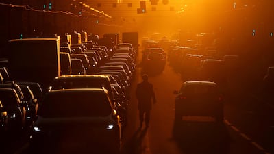 A pedestrian walks in between lines of traffic along Nevsky Avenue in St Petersburg, Russia. Reuters