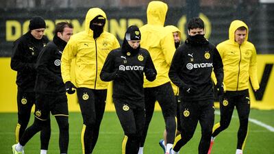 Dortmund's Tobias Raschl (C) and Giovanni Reyna (second right) attend a training session in Dortmund, Germany. EPA