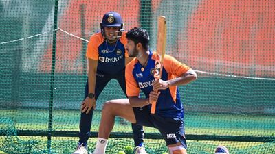 India's Washington Sunda lines-up a shot as his teammate Shubman Gill watches on. AFP