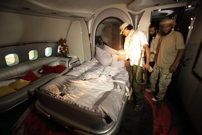 Libyan rebels inspect the inside of Qaddafi's A340 jet, which Al-Kharafi Group tried to seize. AFP